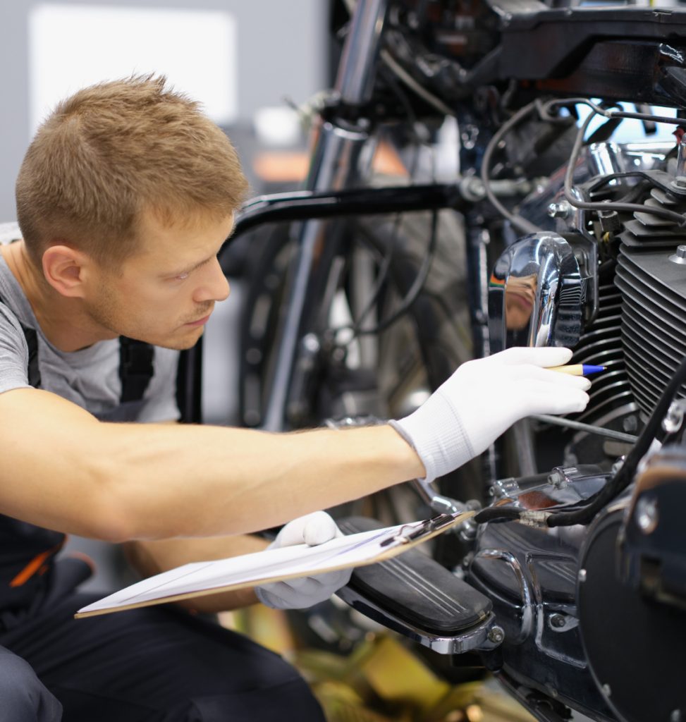 Mechanic inspecting a motorbike - Motorbike MOT Castle Donington